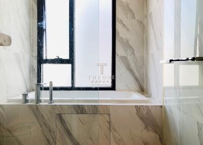 Modern bathroom with marble walls and windows