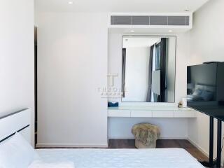 Modern bedroom with a large mirror and desk