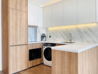 Modern kitchen with wooden cabinets and marble backsplash