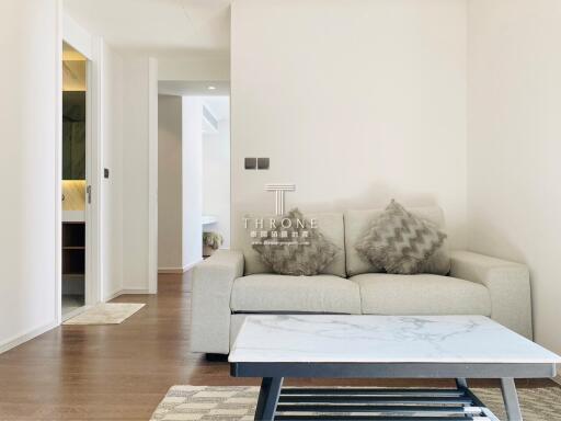 Modern living room with a gray sofa and marble coffee table