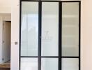 Frosted glass sliding closet doors in a modern bedroom