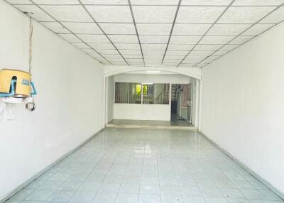 Empty room with tiled floor and ceiling panels