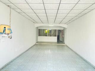 Empty room with tiled floor and ceiling panels