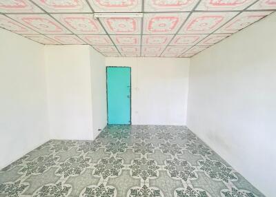 Empty room with colorful patterned ceiling and tiled floor