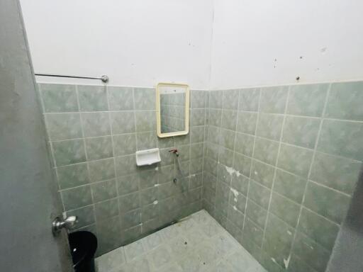 Simple bathroom with tiled walls and a mirror
