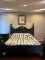 Bedroom with ornate bed and decorative painting above