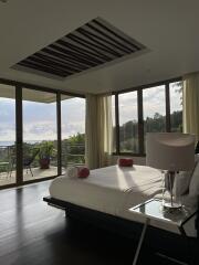 Spacious bedroom with large windows and balcony view