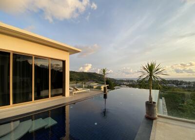 Outdoor view of a modern house with infinity pool and scenic landscape