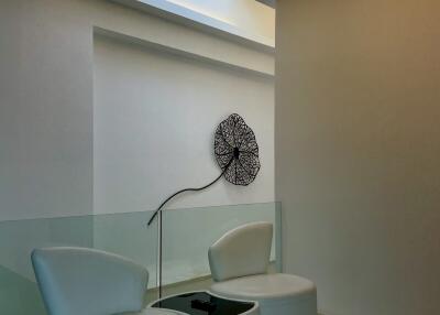 Stylish modern sitting area with unique circular chairs and decorative wall art