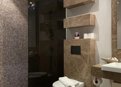 Modern bathroom with stone countertops and mounted shelves