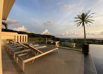 Rooftop with lounge chairs and scenic view