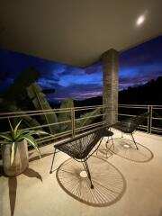 Balcony with chairs and a table at dusk with scenic view