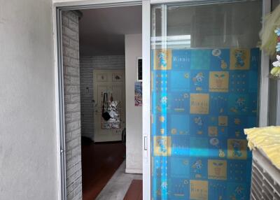 Apartment entrance with sliding glass door and Minnie Mouse curtain