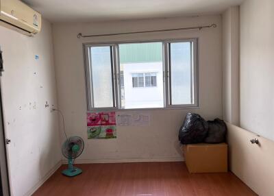 Empty bedroom with window and air conditioning unit