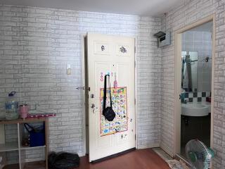 Entryway with decorated door next to a bathroom