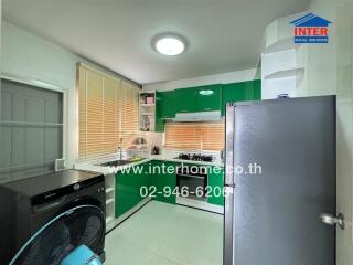 Modern kitchen with green cabinets and stainless steel appliances