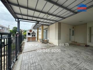 Covered outdoor area with tile flooring and seating