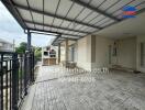 Covered outdoor area with tile flooring and seating