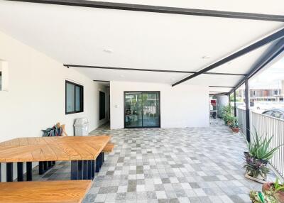 Spacious Covered Patio Area with Table and Plants