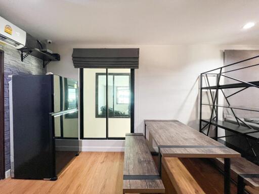 Modern kitchen with a dining area and large refrigerator