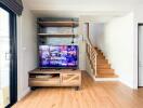 Modern living room with TV and staircase