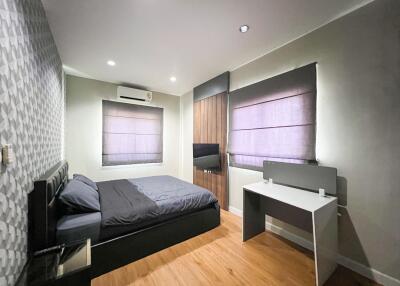 Modern bedroom with wooden floor and contemporary decor