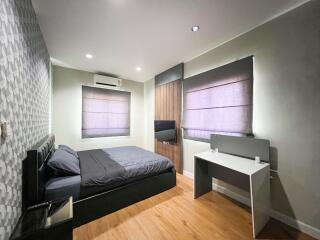 Modern bedroom with wooden floor and contemporary decor