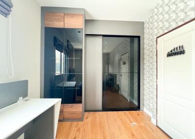 Modern bedroom with sleek furniture and hardwood floors