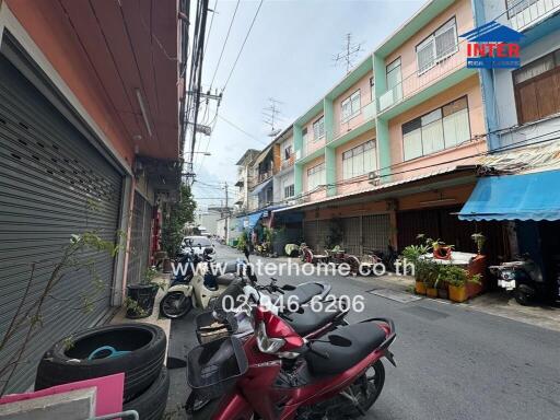 Street view with parked motorbikes in front of residential buildings