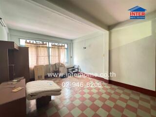 Living room with tiled floor, furniture, and a window