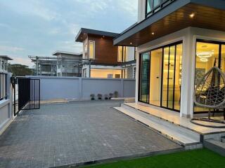 Modern house exterior with patio and large windows