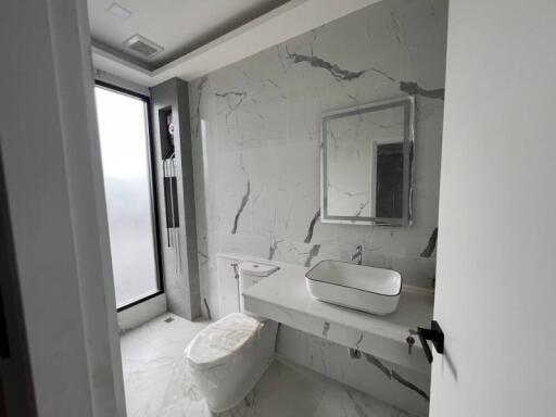 Modern bathroom with large window and marble tiles