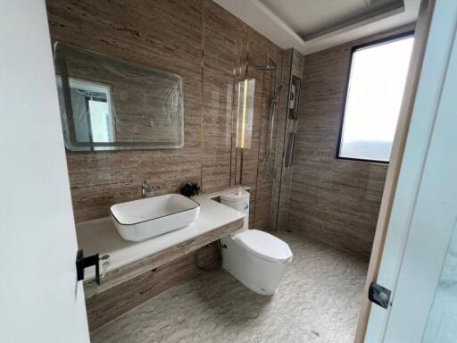 Modern bathroom with large mirror and walk-in shower