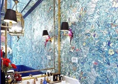 Stylish bathroom with vibrant floral wallpaper and modern fixtures