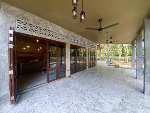 Spacious modern patio with glass doors and ceiling fans