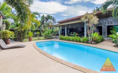 Backyard with a swimming pool and lounge chair