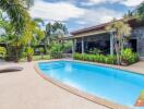 Backyard with a swimming pool and lounge chair