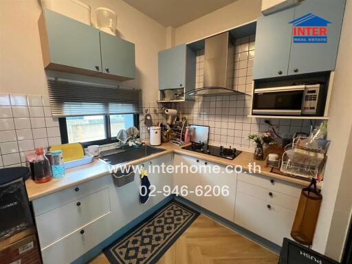 Modern kitchen with blue cabinets and white tile backsplash