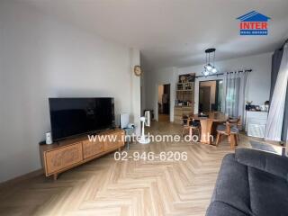 Spacious living room with wooden flooring and dining area