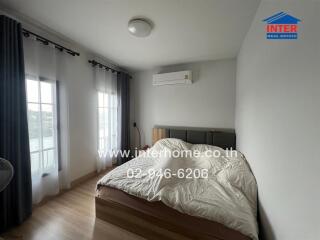 Bedroom with bed, air conditioner and large window