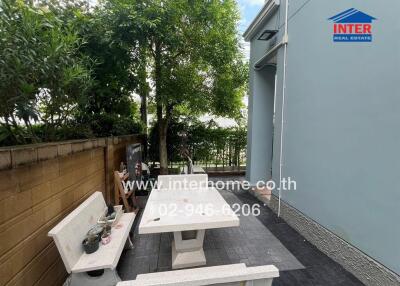 Outdoor seating area with table and benches