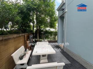 Outdoor seating area with table and benches