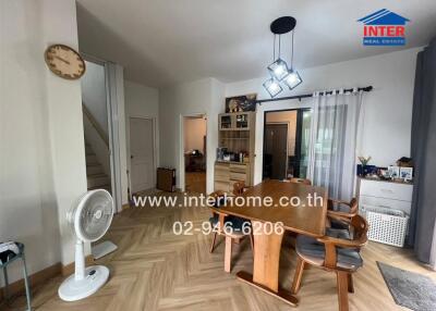 Dining area with modern wooden furniture and contemporary chandelier