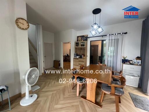 Dining area with modern wooden furniture and contemporary chandelier