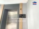 Elevator area with floor number and intercom contact details