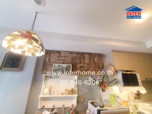 Kitchen with hanging stained glass lamp and shelves