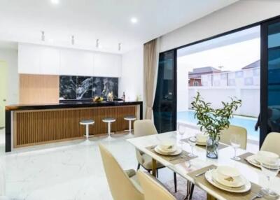 Modern kitchen and dining area with a view of the swimming pool