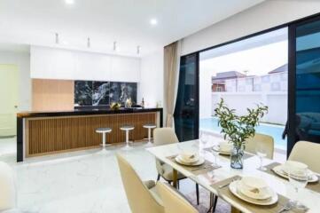 Modern kitchen and dining area with a view of the swimming pool