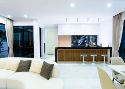 Modern open-plan kitchen and living room with high-end finishes and contemporary furniture
