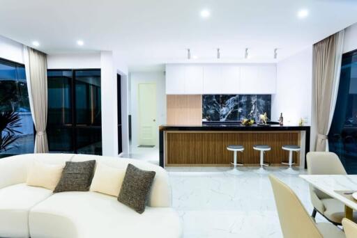 Modern open-plan kitchen and living room with high-end finishes and contemporary furniture